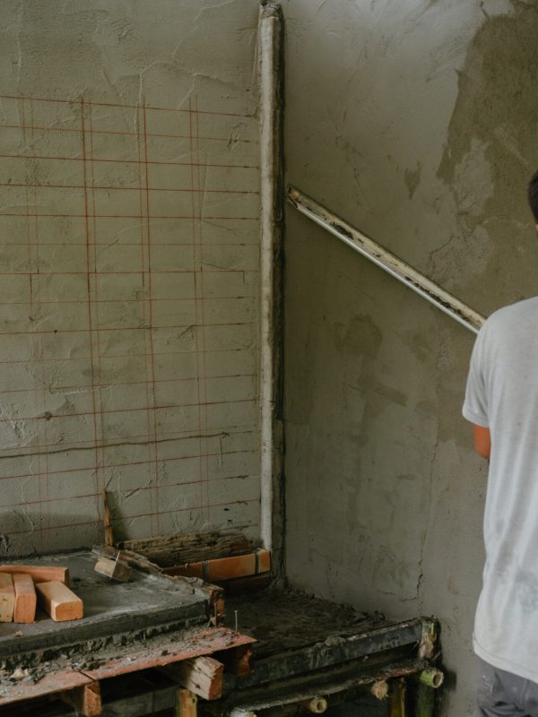 Plasterer renovating indoor walls.